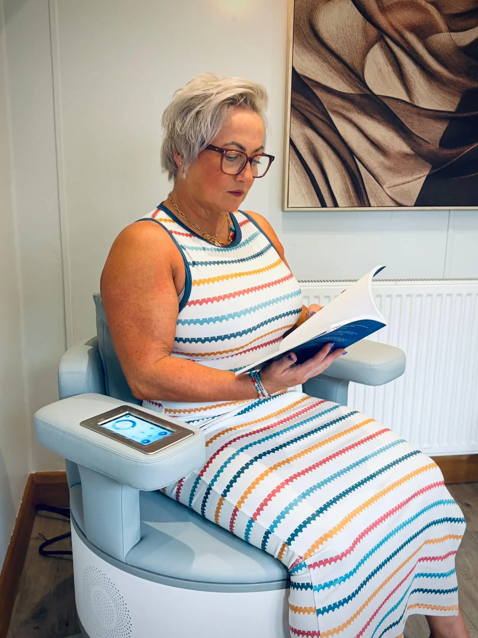 A client using the Ultra Tesla pelvic-floor chair while fully clothed